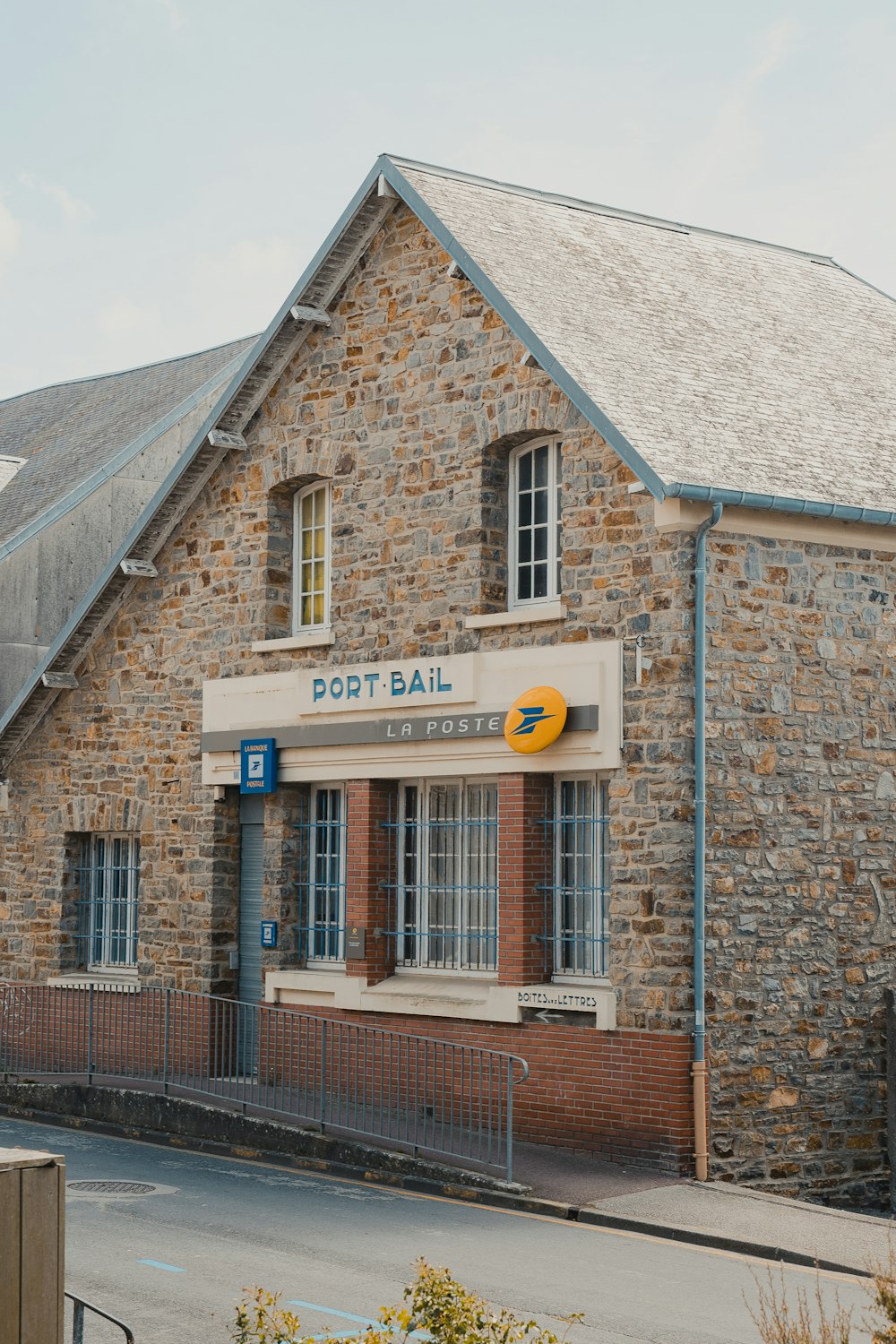 a brick building with a yellow ball on the front