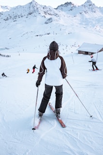 A woman skiing down a snowy mountain wearing a sleek, form-fitting base layer.