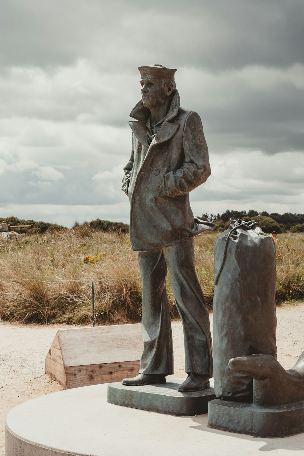 a statue of a man holding a suitcase