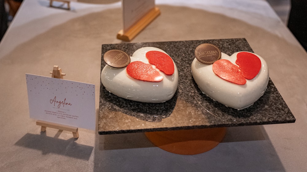 a couple of heart shaped cakes sitting on top of a table