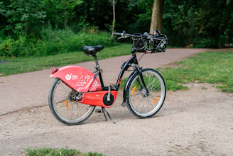 a red bicycle is parked on the side of the road