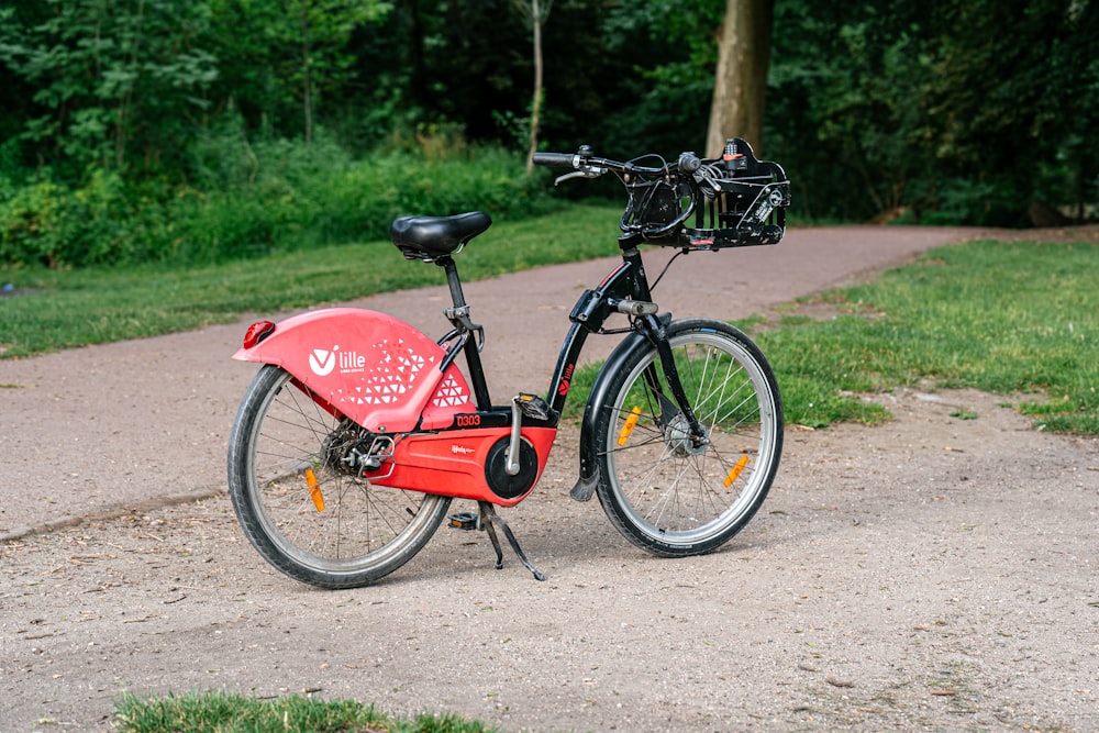 a red bicycle is parked on the side of the road