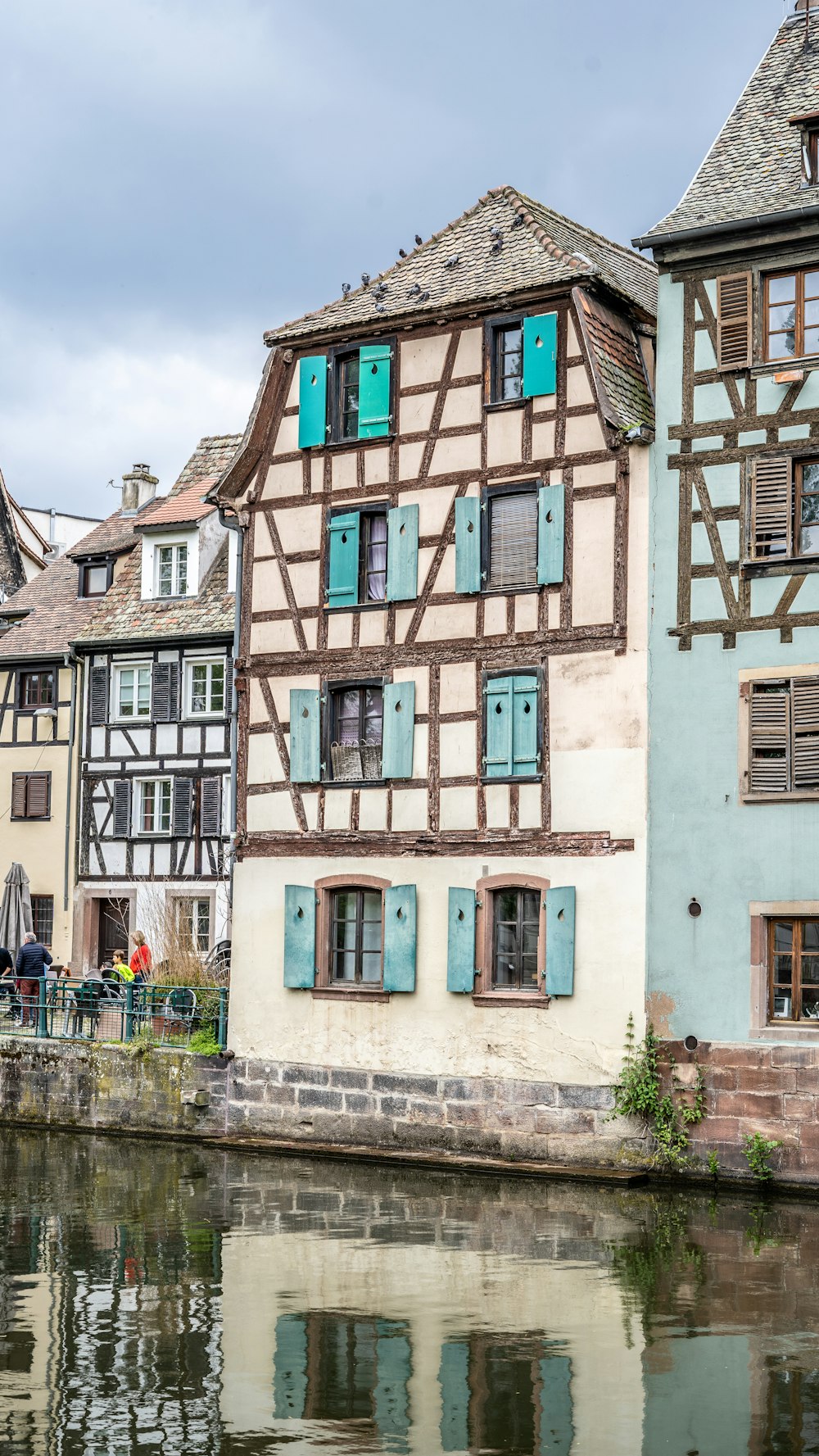 a row of buildings next to a body of water