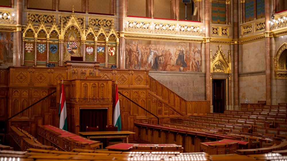 the interior of a large building with wooden pews