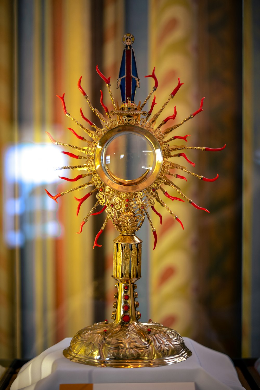 a golden clock with a mirror on top of it