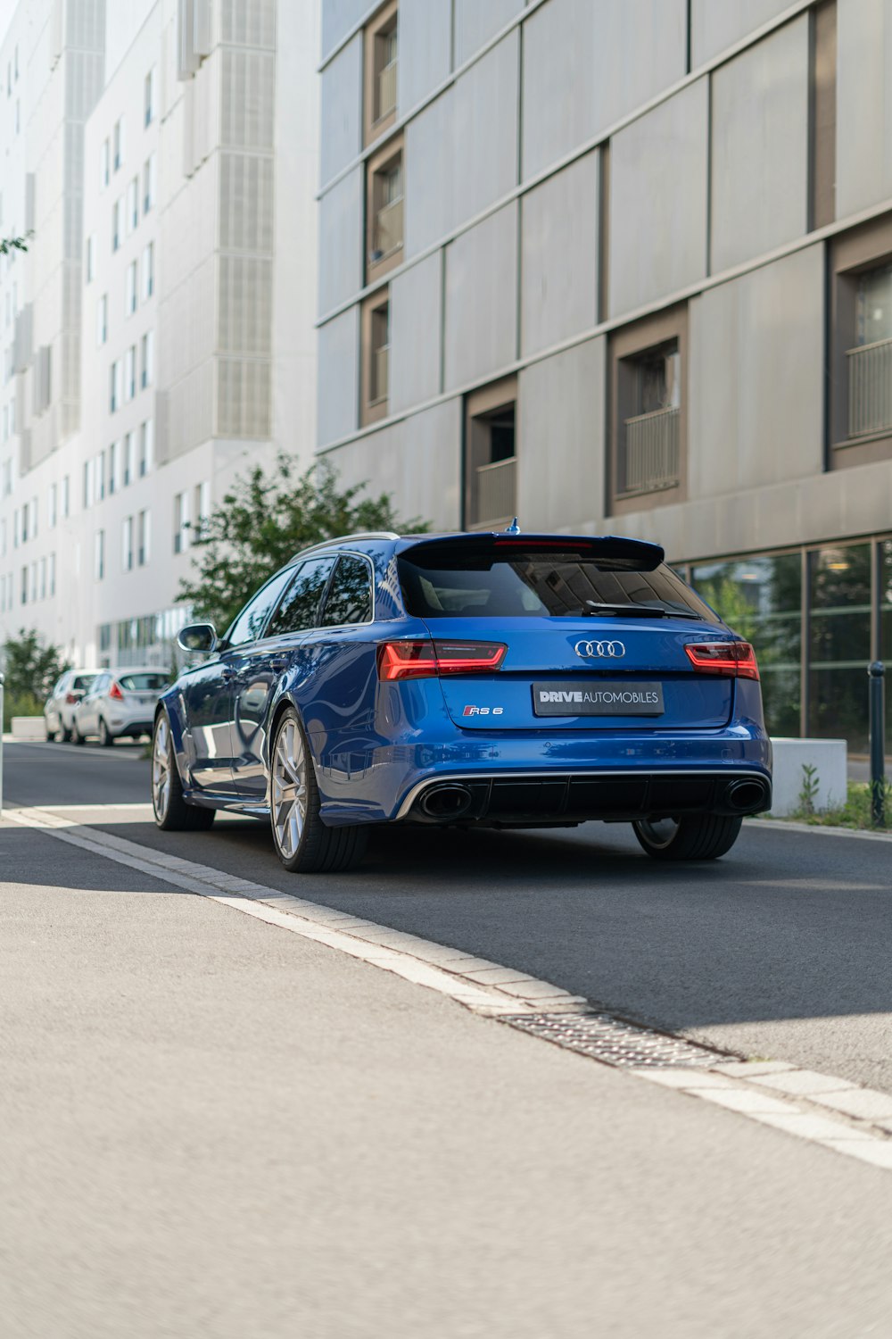 a blue car parked on the side of the road