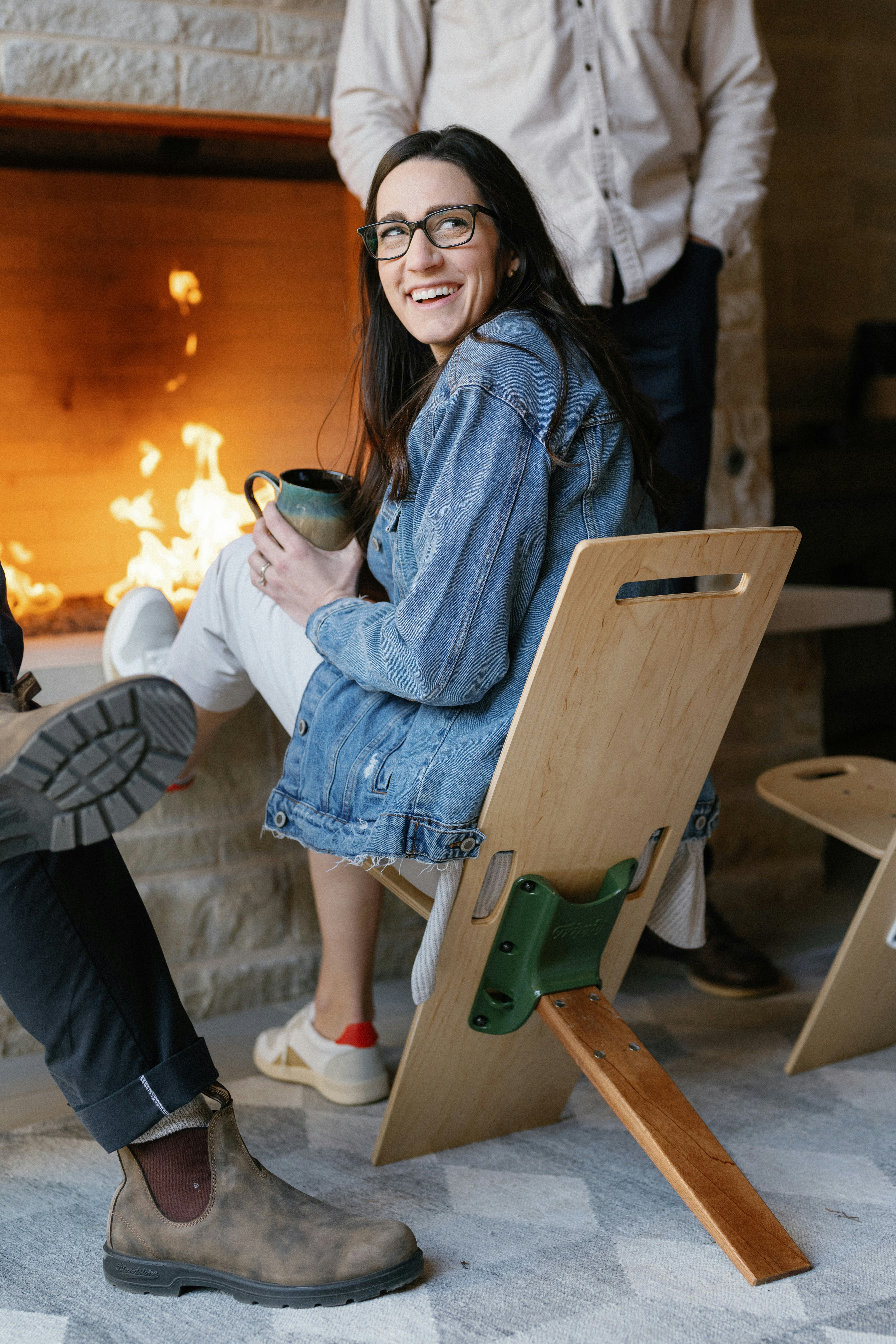 a woman sitting in a chair with a cup of coffee