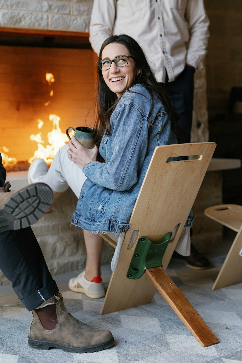 a woman sitting in a chair with a cup of coffee