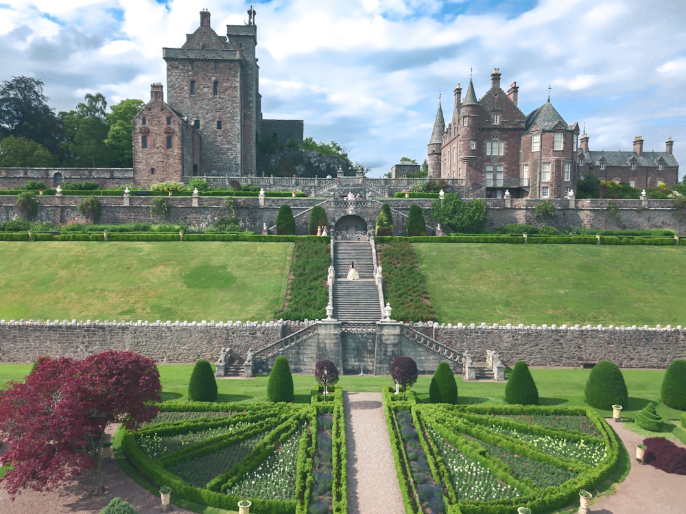 a large castle with a garden in front of it