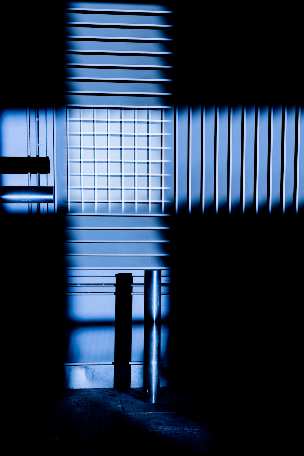 a black and white photo of a bench in a dark room