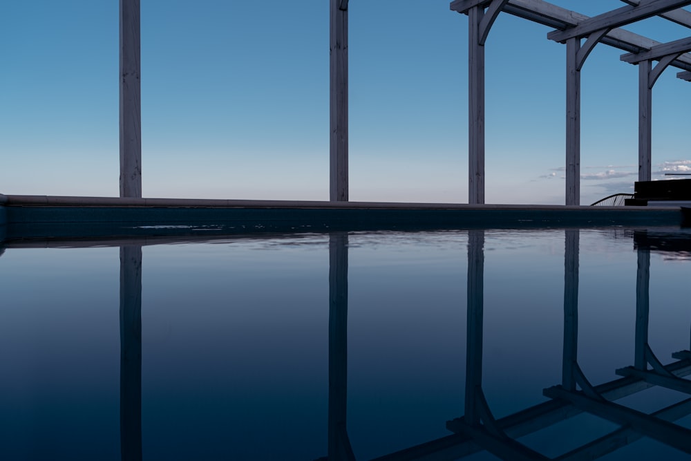 an empty swimming pool with a blue sky in the background