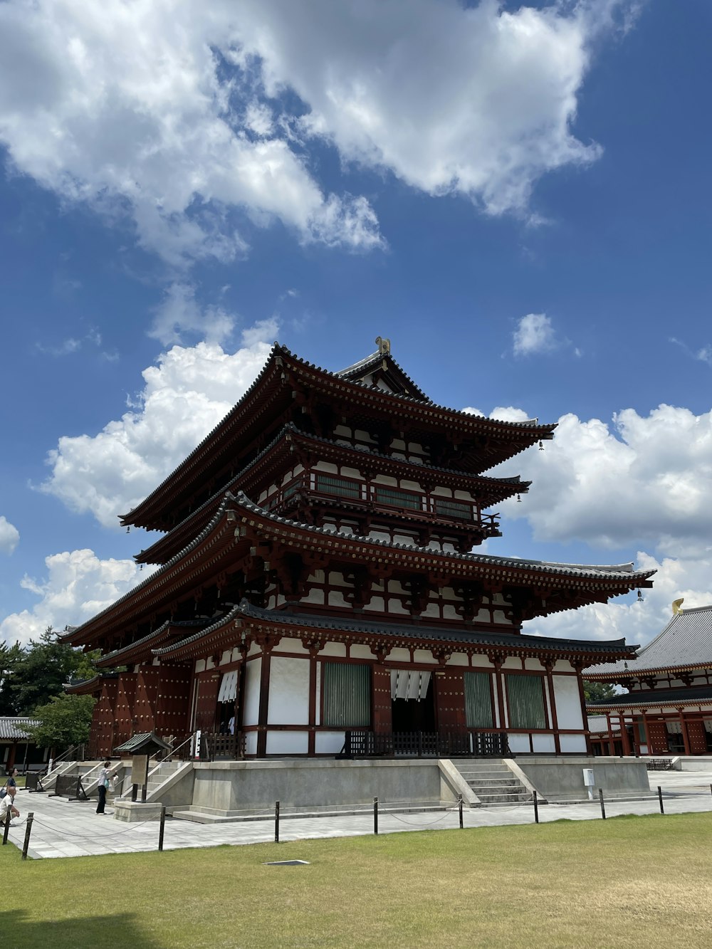 a tall building sitting under a cloudy blue sky