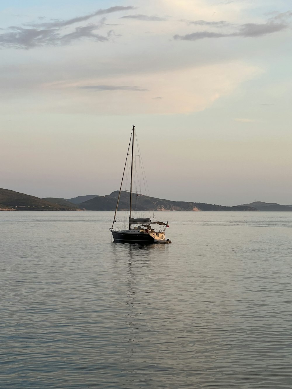 a sailboat floating in the middle of a large body of water