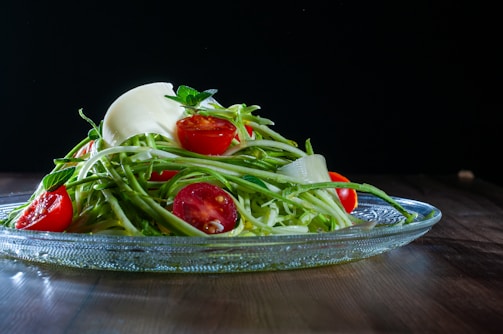 A sleek stainless steel plate holding a vibrant salad, ready to serve.