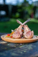 Close-up of a juicy lamb chop glazed with a rich sauce, served with roasted vegetables.