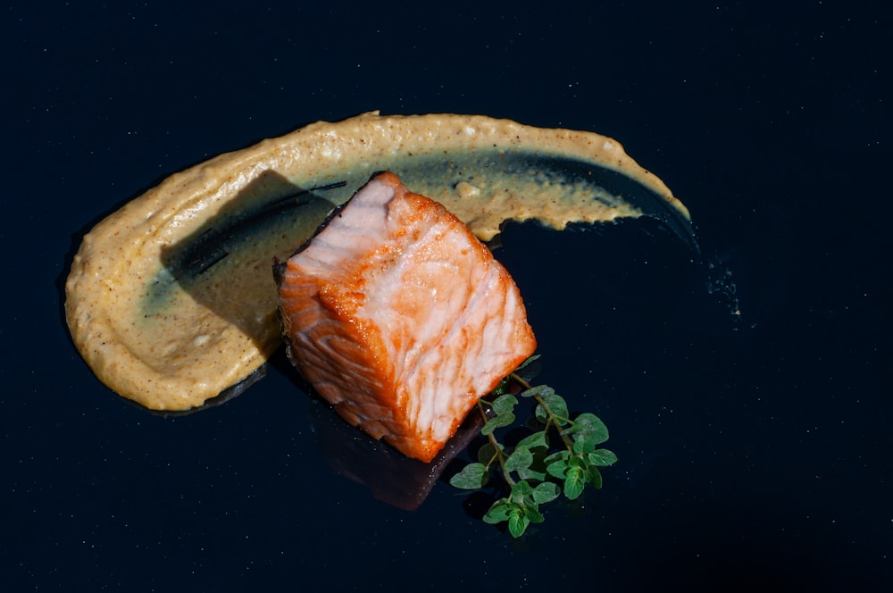 a piece of fish sitting on top of a banana