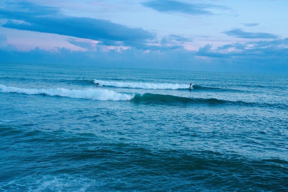 a person riding a wave on top of a surfboard