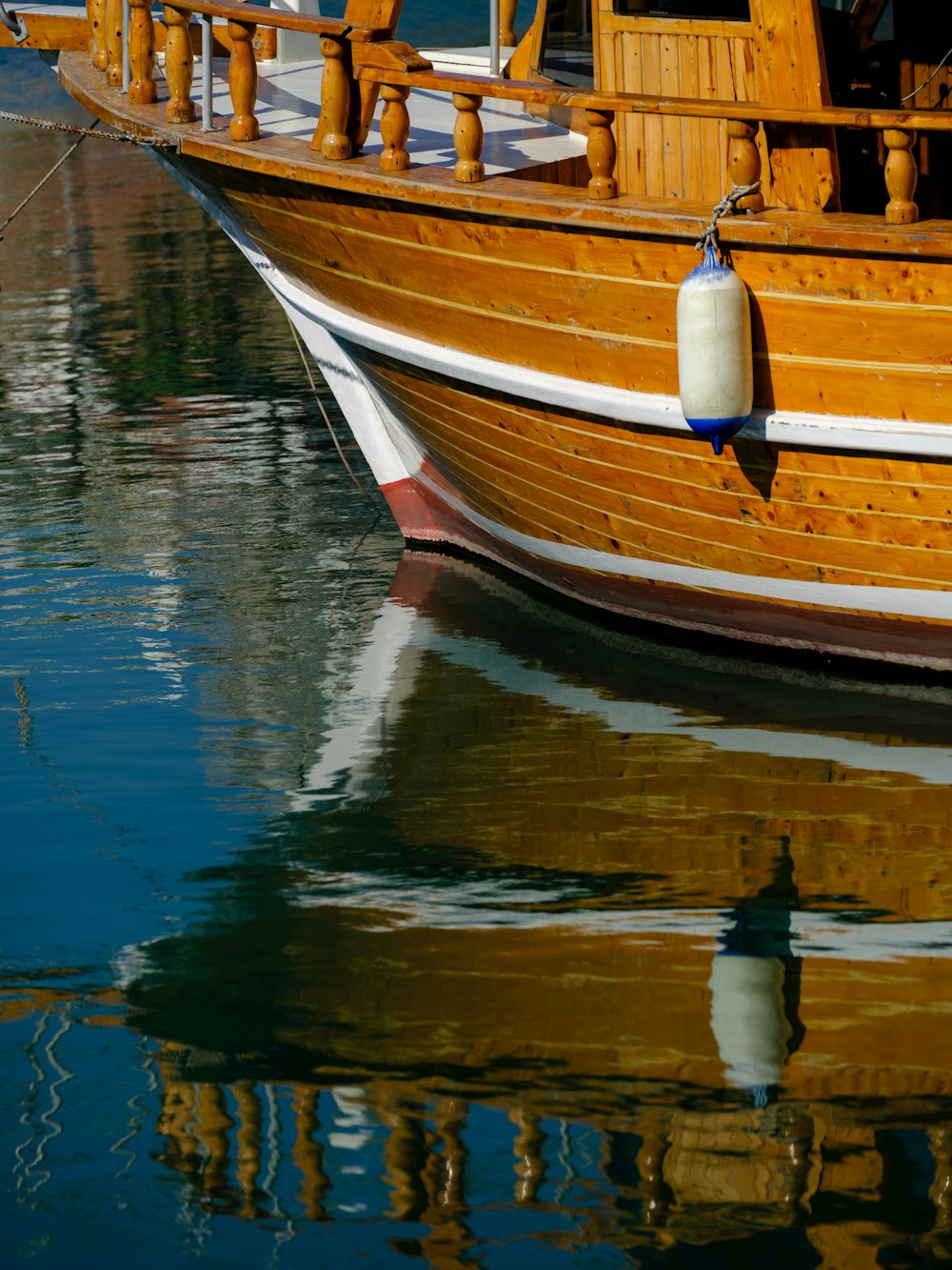 a large wooden boat floating on top of a body of water