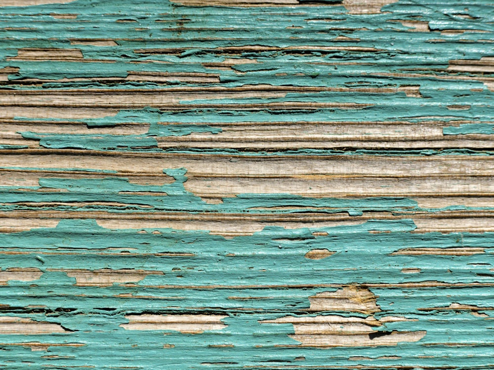 a close up of a piece of wood with peeling paint