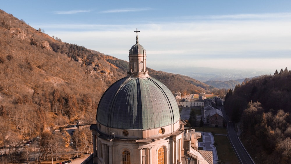 an aerial view of a church in the mountains