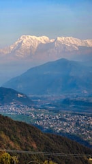 A vibrant image of Manali showcasing snow-capped mountains and lush green valleys.