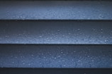 a close up of a blue wall with water droplets
