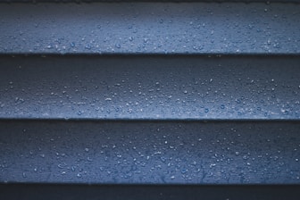 a close up of a blue wall with water droplets
