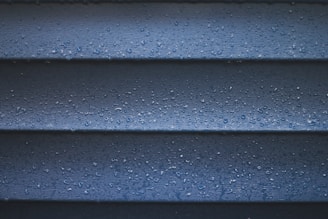 a close up of a blue wall with water droplets