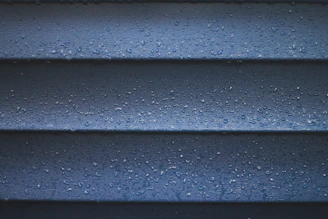 a close up of a blue wall with water droplets