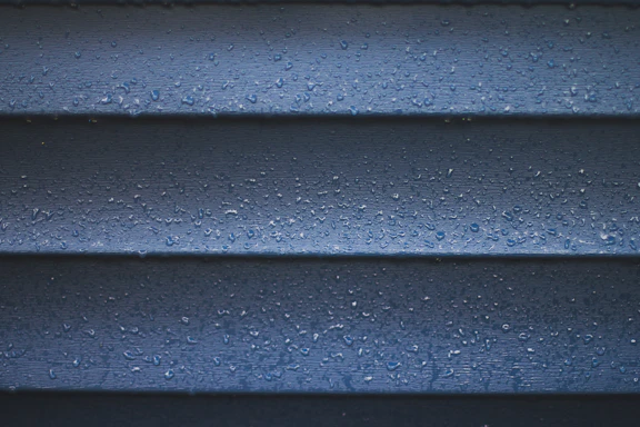 a close up of a blue wall with water droplets