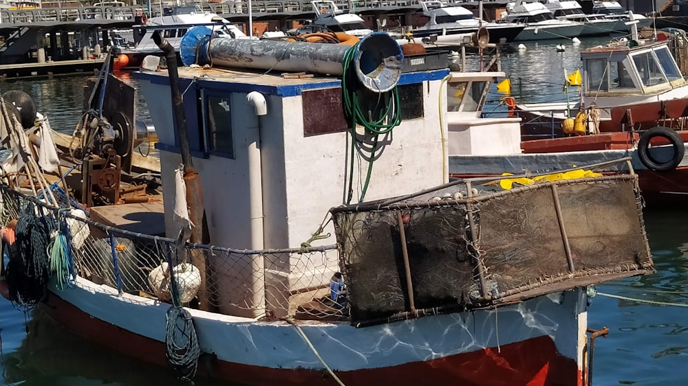 a boat docked in a harbor with other boats in the background