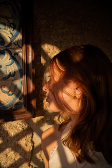 A warm, intimate portrait of Aduke Aladekomo bathed in golden light, embodying soulful elegance.