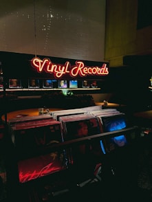 a large neon sign that reads vinyl records