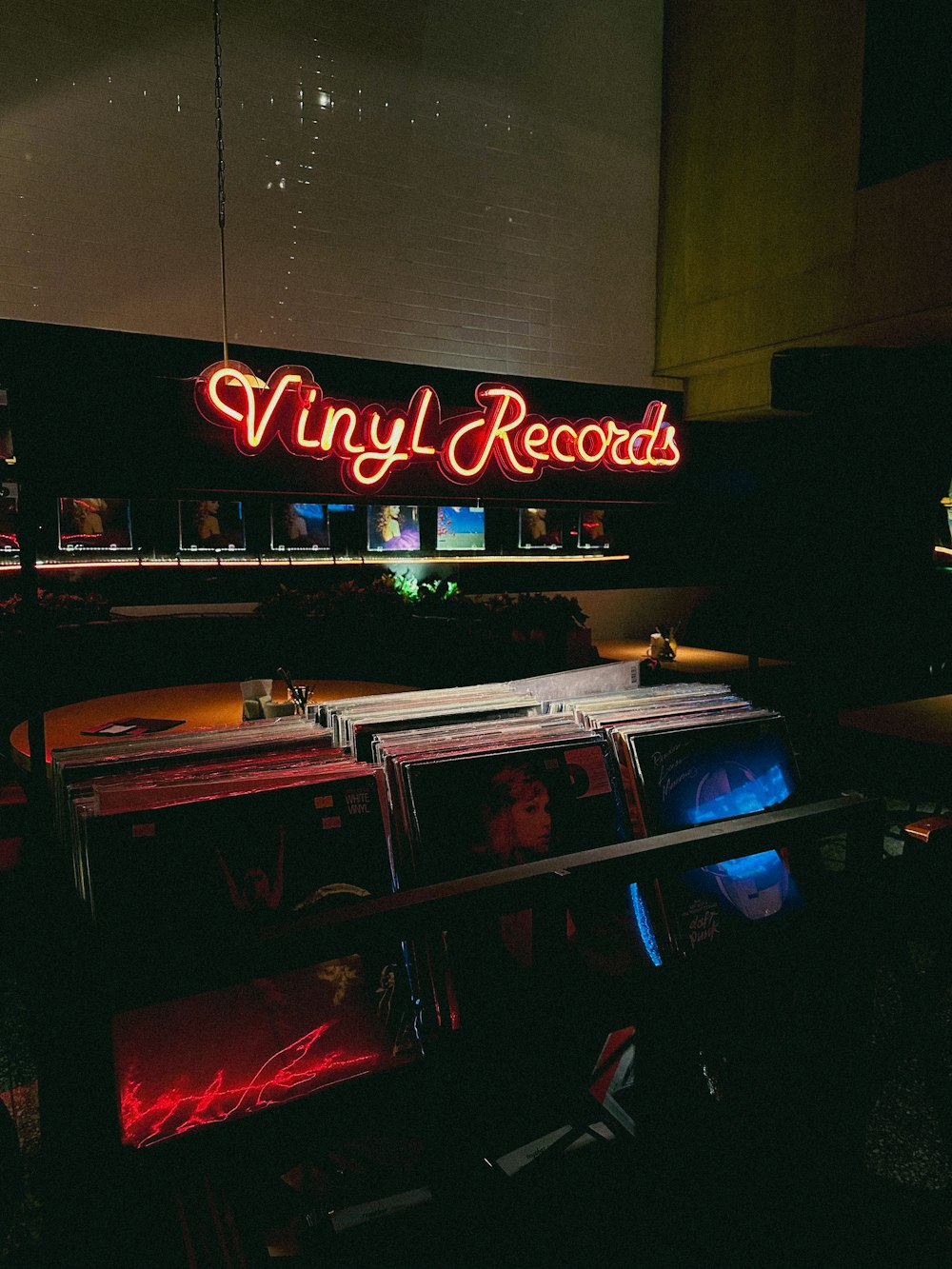 a large neon sign that reads vinyl records
