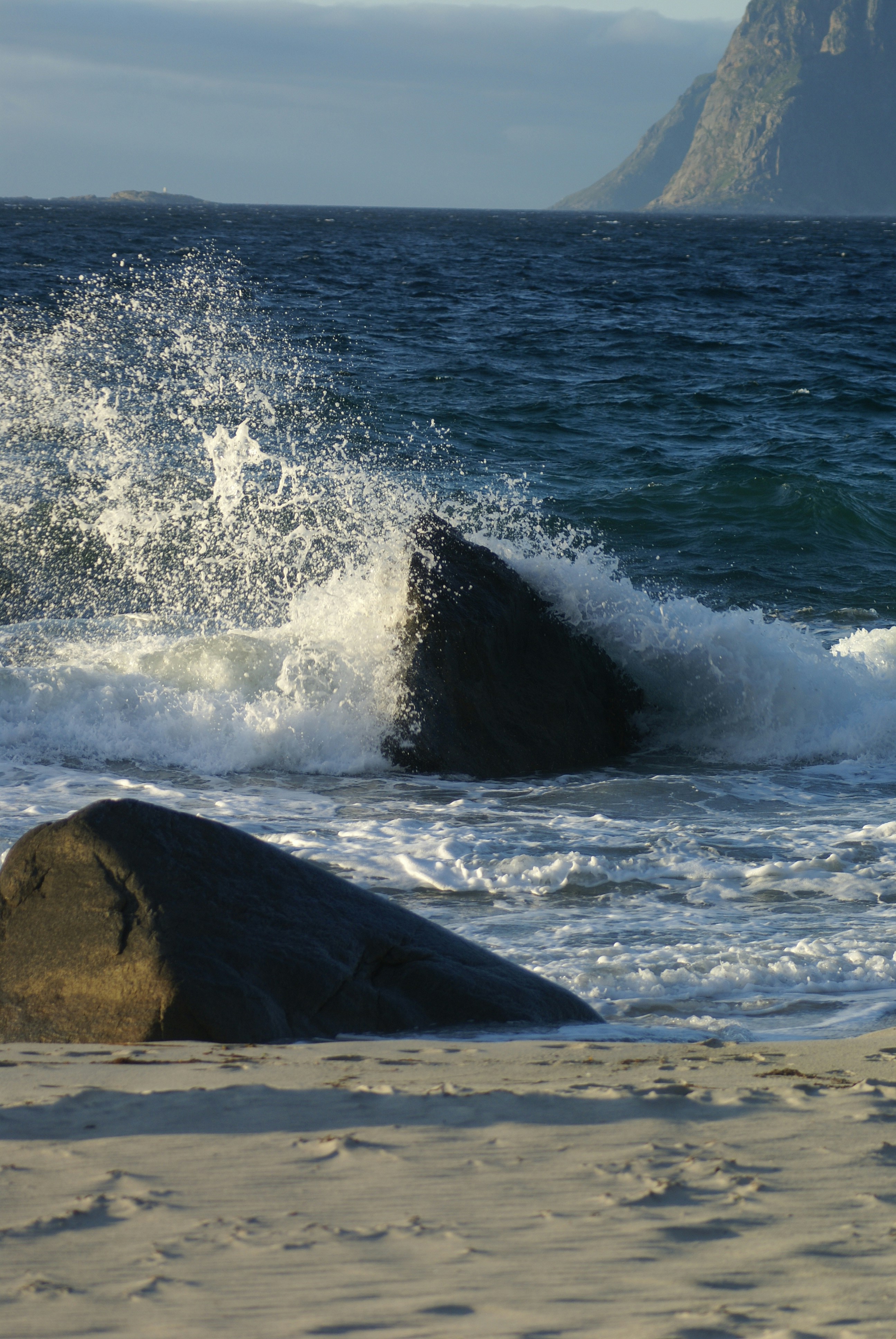 A large rock sitting on top of a sandy beach photo – Free Sea Image on ...