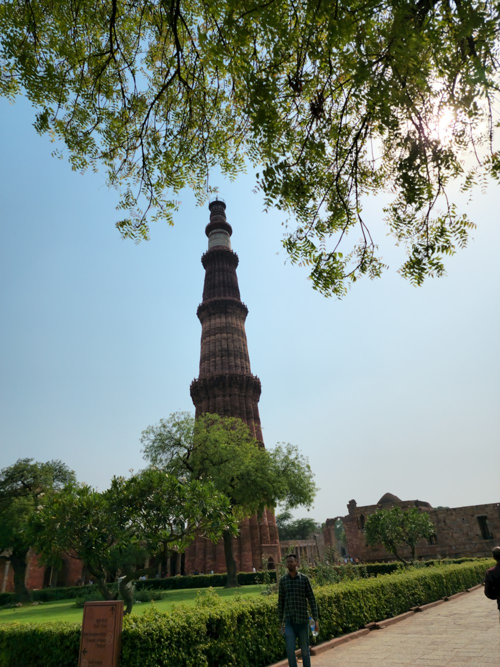 a man standing in front of a tall tower