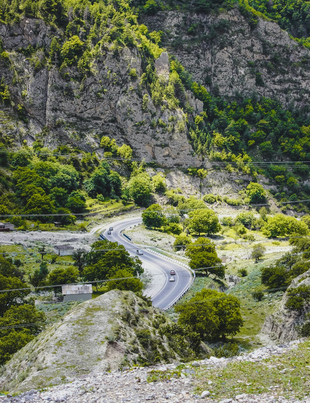 a car driving down a winding road in the mountains