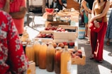 Children enjoying tasting fresh organic fruits in a sunny open-air market.