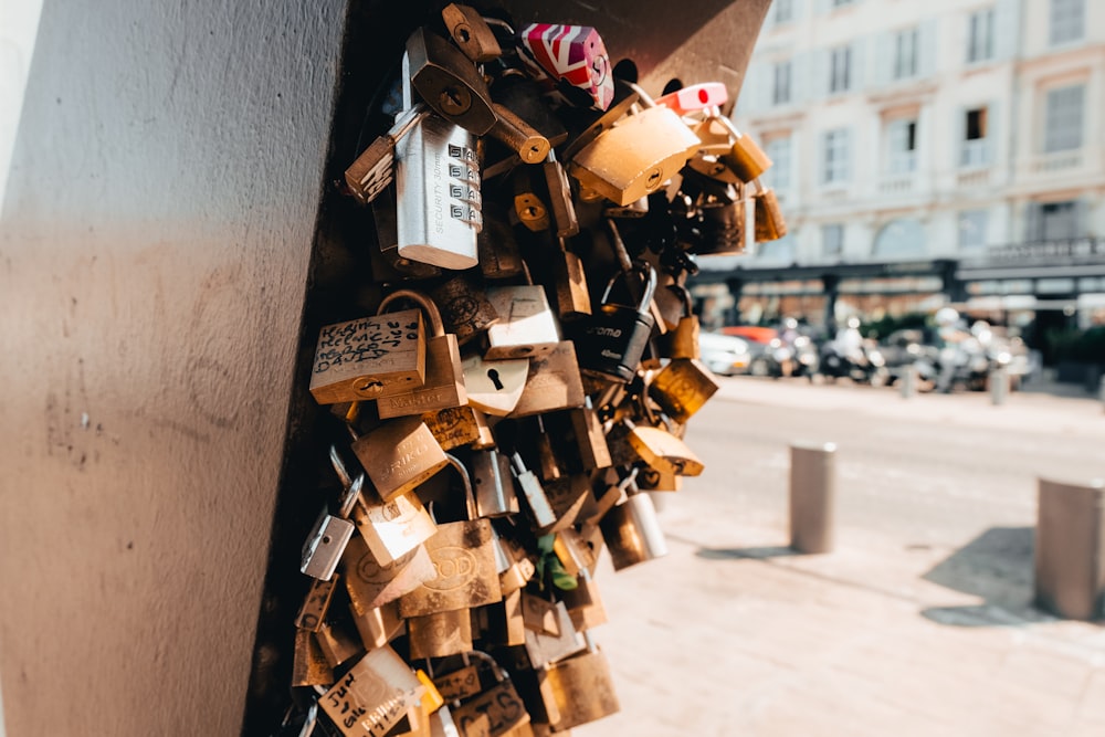 a bunch of padlocks are attached to a wall