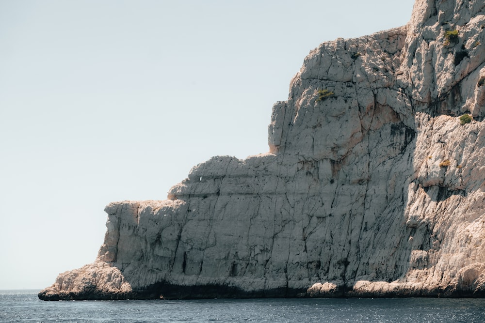 a large rock outcropping in the middle of the ocean
