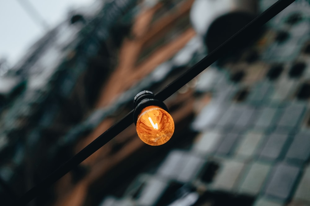 a close up of a street light with a building in the background