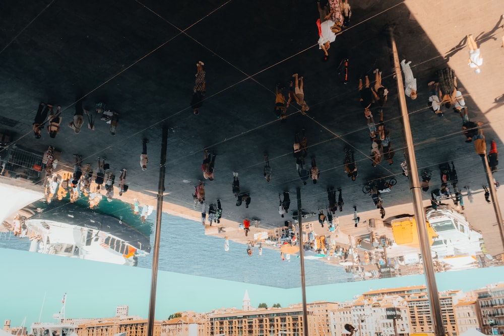 a group of people hanging from a bridge over water