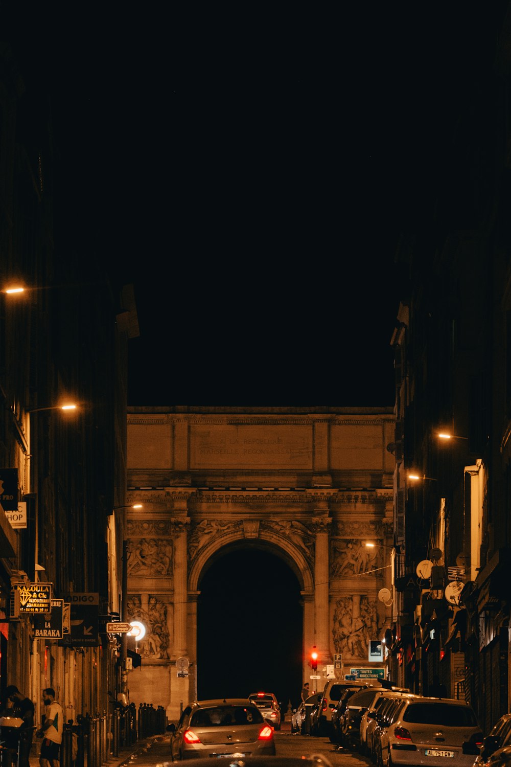 a city street filled with lots of traffic at night