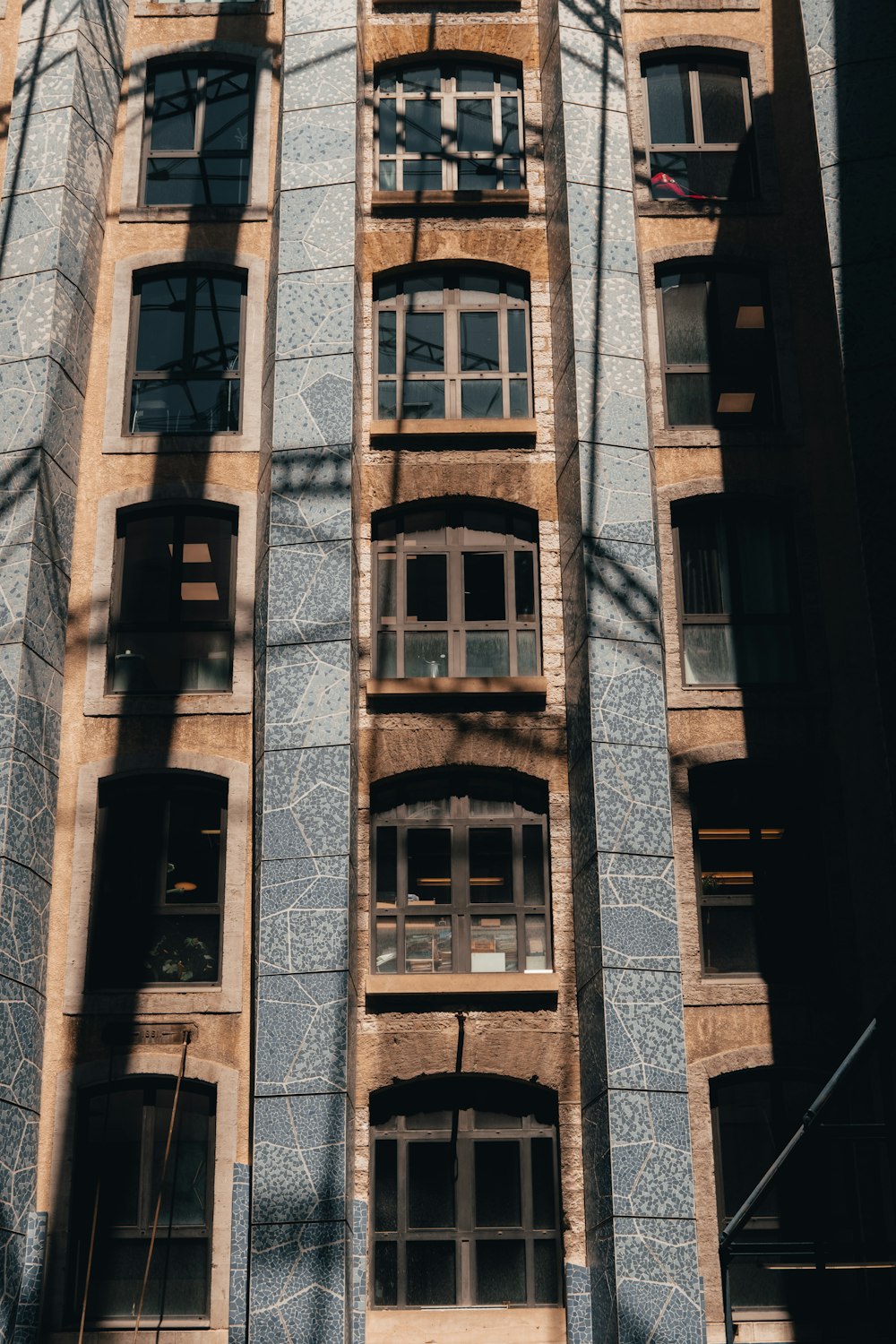 a tall building with lots of windows next to a street