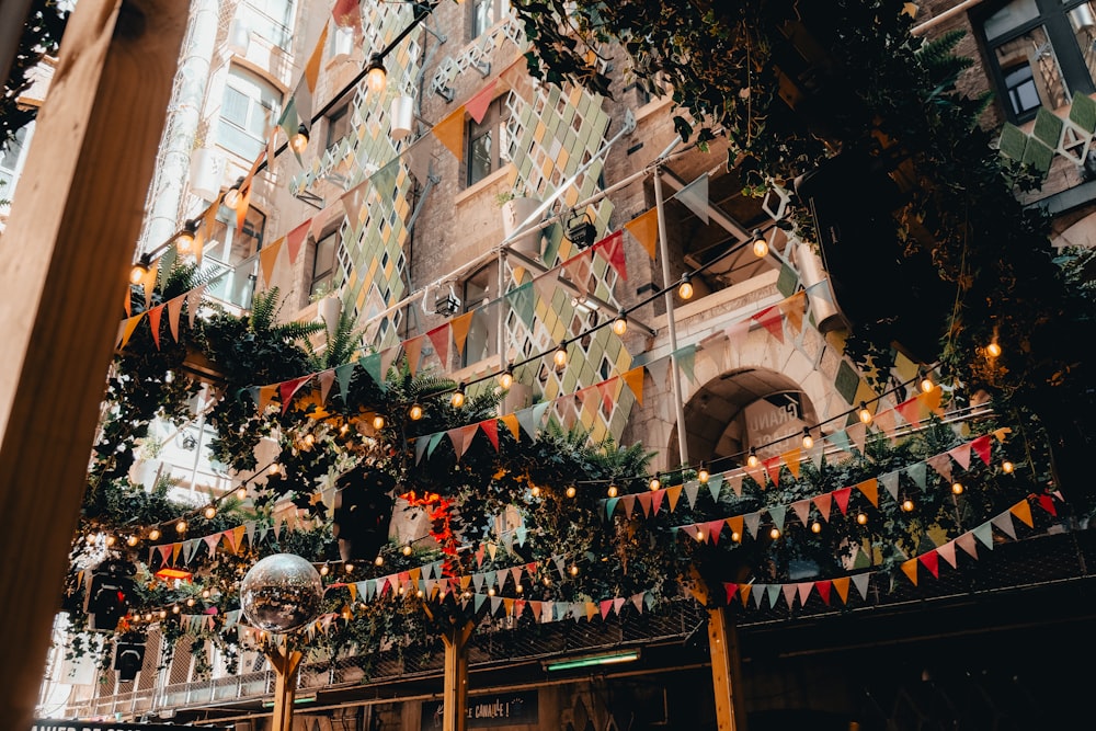 a building with a bunch of flags hanging from it's sides