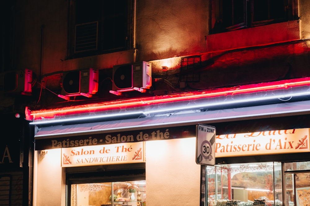 a store front with a neon sign above it