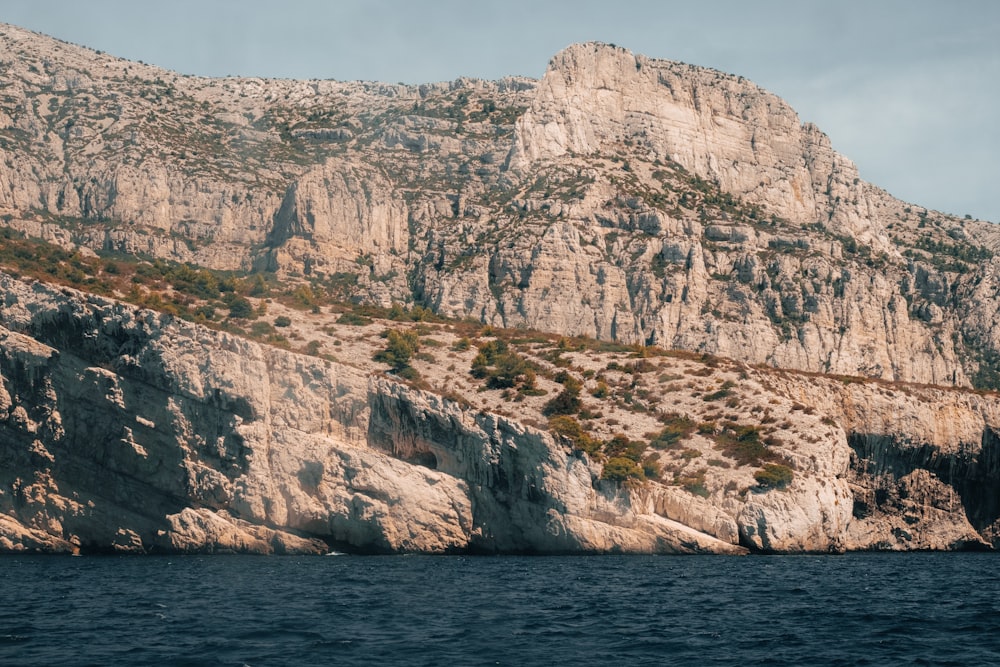 a large mountain with a steep cliff on the side of it