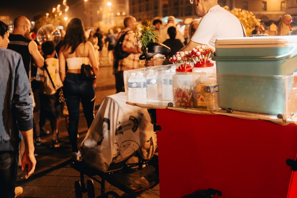 a group of people standing around a food cart