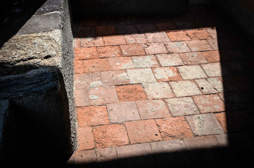 a brick walkway with a shadow of a person