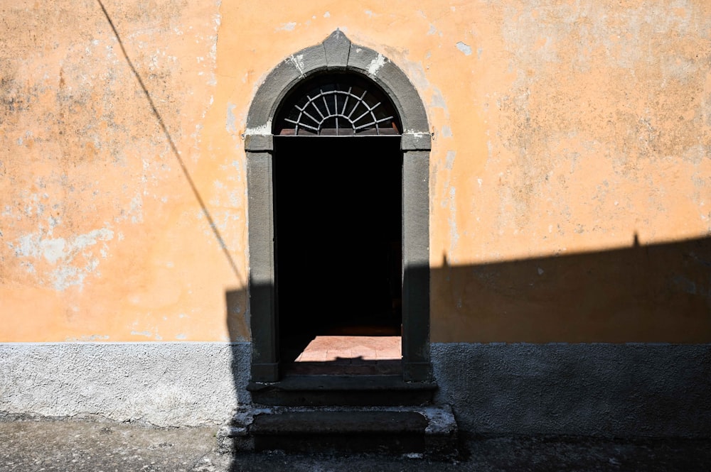 a doorway with a clock on the outside of it